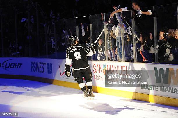 Drew Doughty of the Los Angeles Kings gives his stick to a fan after defeating the Vancouver Canucks in Game Three of the Western Conference...