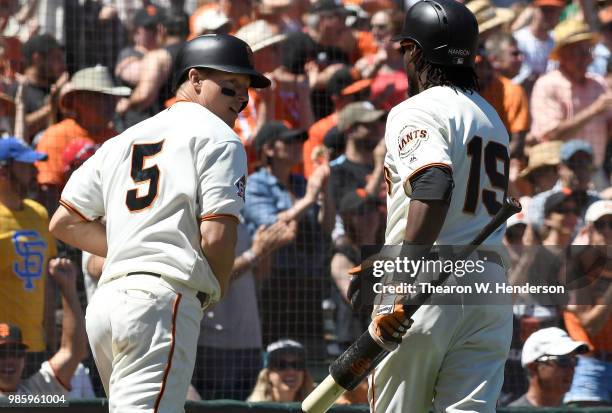 Nick Hundley of the San Francisco Giants is congratulated by Alen Hanson aftr Hundley scored against the San Diego Padres in the bottom of the...