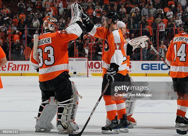 Brian Boucher and Jeff Carter of the Philadelphia Flyers celebrate after defeating the New Jersey Devils in Game Four of the Eastern Conference...