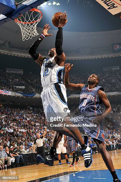 Dwight Howard of the Orlando Magic shoots against Nazr Mohammed of the Charlotte Bobcats in Game Two of the Eastern Conference Quarterfinals during...