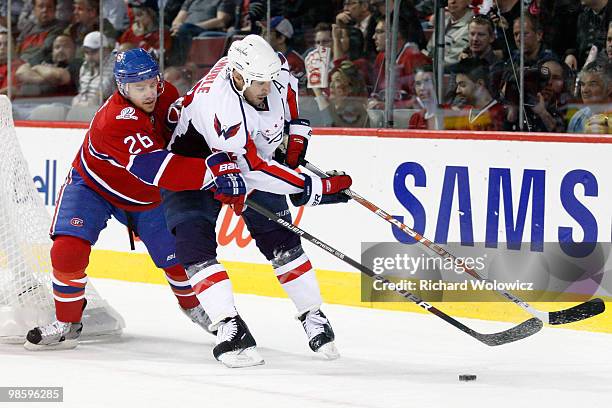 Mike Knuble of the Washington Capitals stick handles the puck while being defended by Josh Gorges of the Montreal Canadiens in Game Four of the...