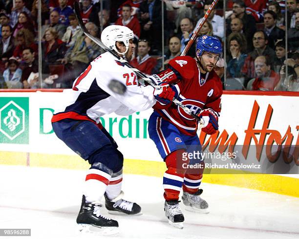 Brian Gionta of the Montreal Canadiens clears the puck while being checked by Mike Knuble of the Washington Capitals in Game Four of the Eastern...