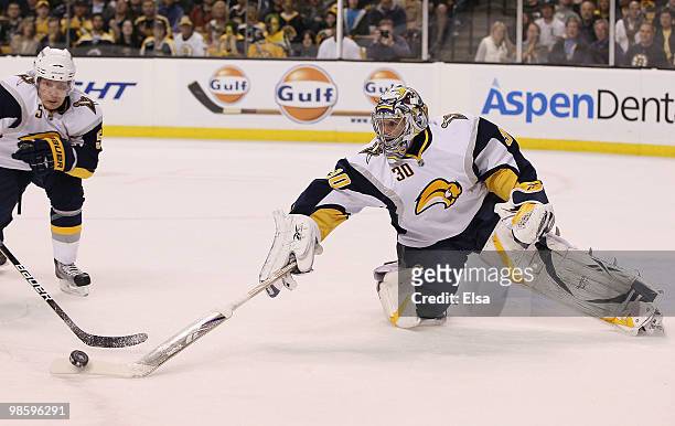 Ryan Miller of the Buffalo Sabres clears a shot by the Boston Bruins as teammate Toni Lydman stands by in Game Four of the Eastern Conference...