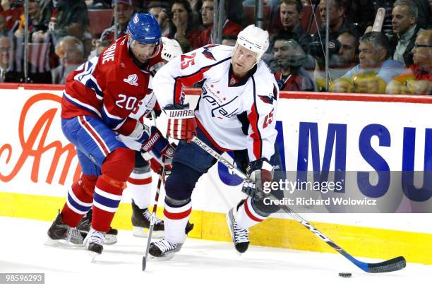 Jason Chimera of the Washington Capitals skates with the puck while being defended by Ryan O'Byrne of the Montreal Canadiens in Game Four of the...