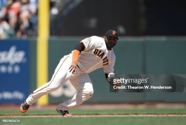 Pablo Sandoval of the San Francisco Giants reacts to this ground ball that goes for a base hit off the bat of A.J. Ellis of the San Diego Padres in...