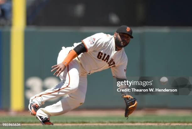 Pablo Sandoval of the San Francisco Giants reacts to this ground ball that goes for a base hit off the bat of A.J. Ellis of the San Diego Padres in...