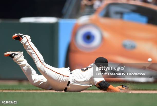 Pablo Sandoval of the San Francisco Giants dives for this ball that goes for a base hit off the bat of A.J. Ellis of the San Diego Padres in the top...