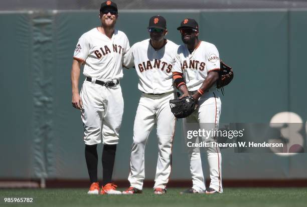 Hunter Pence, Gorkys Hernandez and Andrew McCutchen of the San Francisco Giants celebrates defeating the San Diego Padres 5-3 at AT&T Park on June...