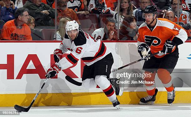 Andy Greene of the New Jersey Devils skates against Jeff Carter of the Philadelphia Flyers in Game Four of the Eastern Conference Quarterfinals...