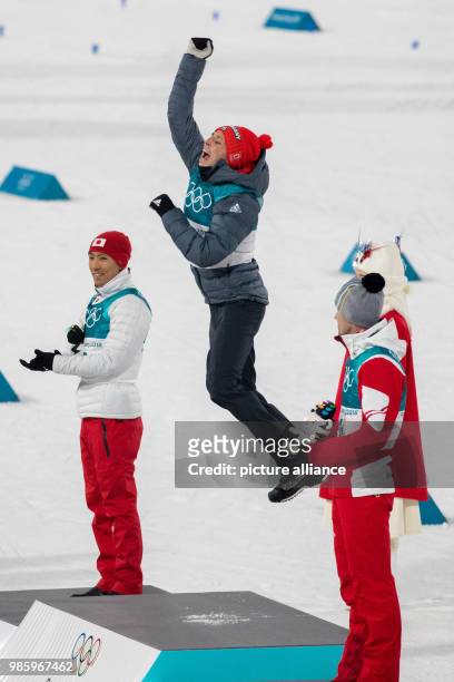 Winner Eric Frenzel from Germany celebrating with second-placed Akito Watabe from Japan and third-placed Lukas Klapfer from Austria after his victory...