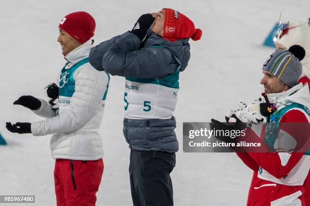 Winner Eric Frenzel from Germany celebrating with second-placed Akito Watabe from Japan and third-placed Lukas Klapfer from Austria after his victory...