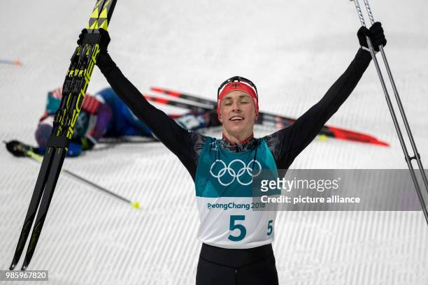 Winner Eric Frenzel from Germany celebrating his victory at the finish line during the Nordic combined event in the Alpensia Ski Jump Centre in...
