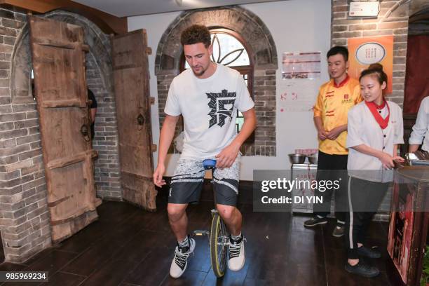 Player Klay Thompson of the Golden State Warriors plays a wheelbarrow on June 27, 2018 in Taiyuan, China.