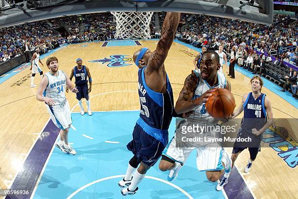 Marcus Thornton of the New Orleans Hornets takes the ball to the basket against Erick Dampier of the Dallas Mavericks during the game at New Orleans...