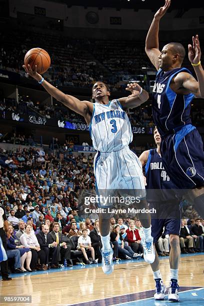 Chris Paul of the New Orleans Hornets shoots a layup against Caron Butler of the Dallas Mavericks during the game at New Orleans Arena on March 22,...