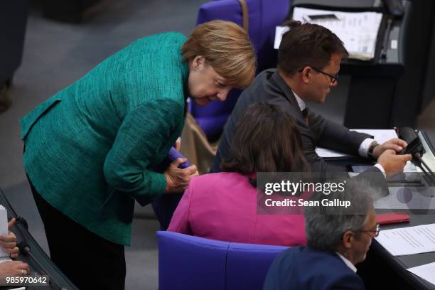 German Chancellor and leader of the German Christian Democrats Angela Merkel speaks with Andrea Nahles, head of the Bundestag faction of the German...