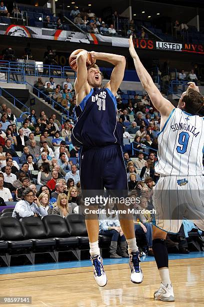 Dirk Nowitzki of the Dallas Mavericks shoots a jump shot against Darius Songaila of the New Orleans Hornets during the game at New Orleans Arena on...