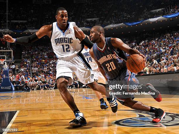 Raymond Felton of the Charlotte Bobcats drives against Dwight Howard of the Orlando Magic in Game Two of the Eastern Conference Quarterfinals during...