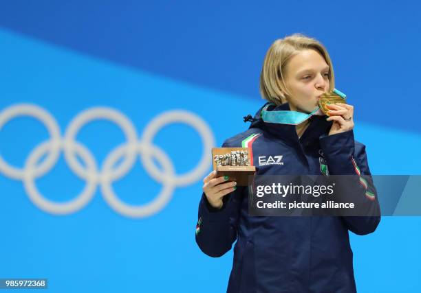 Dpatop - Italian gold medallist Arianna Fontana kisses her medal while celebrating on the podium during the medal ceremony of the women's 500m short...