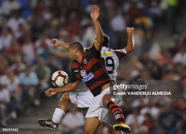 Flamengo's Adriano vies for the ball with Caracas' Giova during their football match for the Libertadores Cup at Maracana stadium in Rio de Janeiro,...