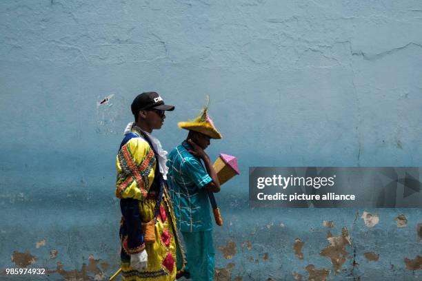 Two members of a Maracatu group dressed in costumes take part in a carnival in Nazare de Mata, Brazil, 13 February 2018. Photo: Diego Herculano/dpa