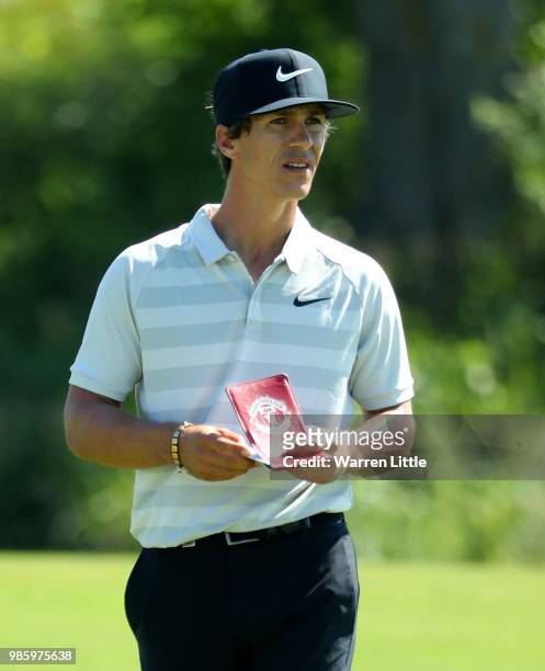 Thorbjorn Olesen of Denmark prepares Thorbjorn Olesen of Denmark play his second shot on the 1st hole during the first round of the HNA Open de...