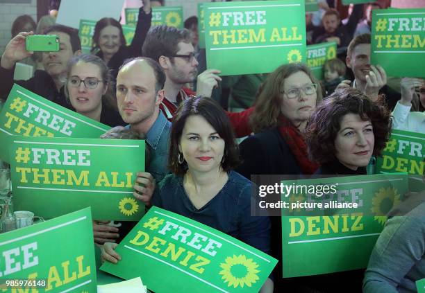 Federal chairwoman of the Alliance 90/Green Party, Annalena Baerbock , and other party members hold up placards in solidarity for journalist Deniz...