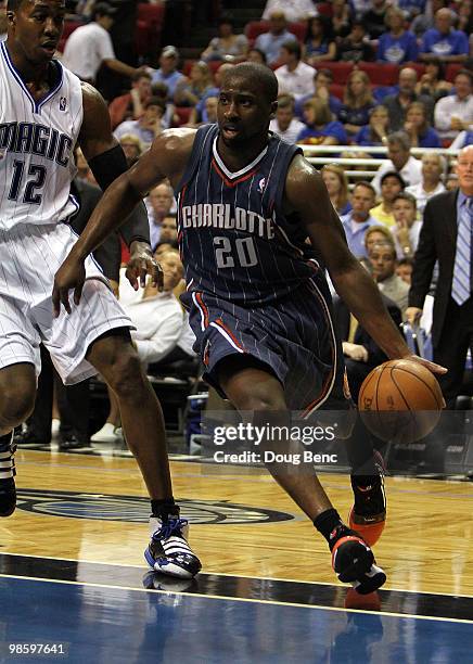 Raymond Felton of the Charlotte Bobcats drives around Dwight Howard of the Orlando Magic in Game Two of the Eastern Conference Quarterfinals during...