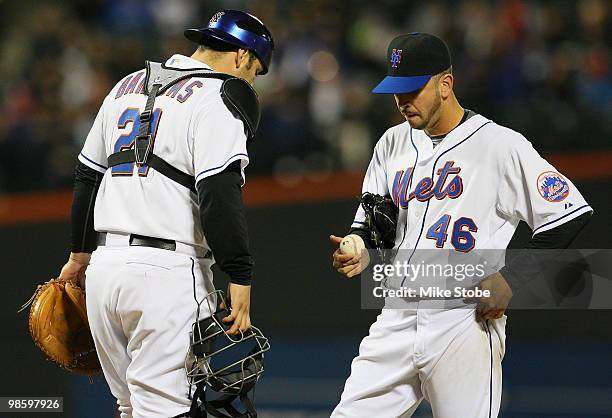 Oliver Perez of the New York Mets is visited by Rod Barajas during their game against the Chicago Cubs on April 21, 2010 at Citi Field in the...