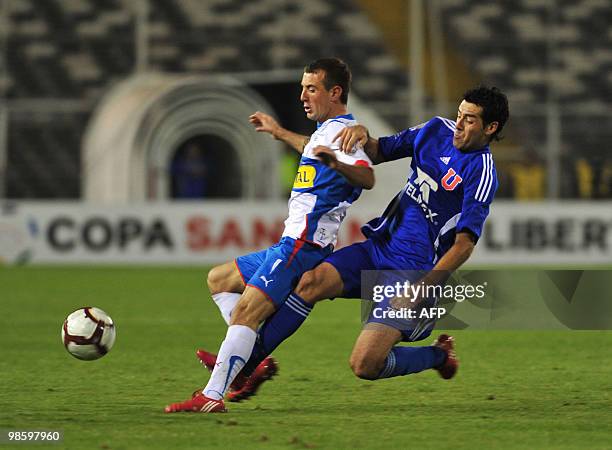 Universidad de Chile's Nelson Pinto vies for the ball with Universidad Catolica's Hans Martinez during their Copa Libertadores 2010 football match at...