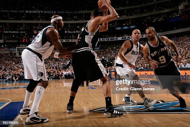 Tim Duncan and Tony Parker of the San Antonio Spurs work the pick and roll against Jason Kidd and Erick Dampier of the Dallas Mavericks in Game Two...