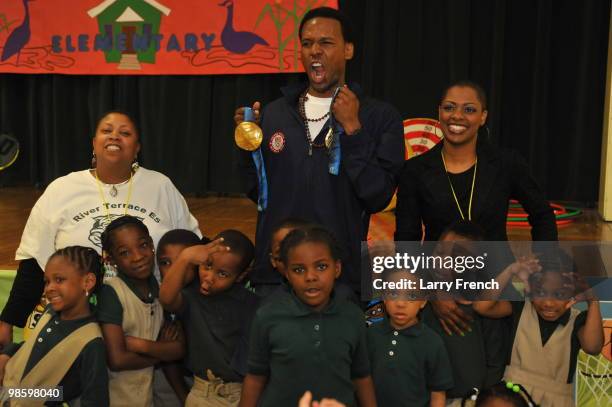 Vancouver 2010 United States Olympic gold medalist Shani Davis poses with the children of River Terrace Elementary School during a visit by Olympic...