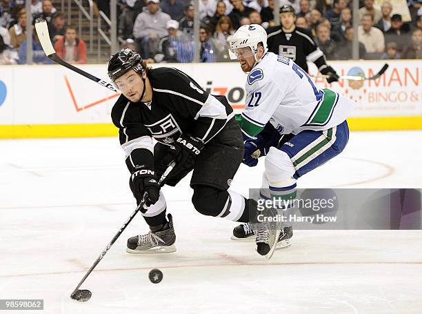 Drew Doughty of the Los Angeles Kings clears the puck in front of Daniel Sedin of the Vancouver Canucks during the first period in game four of the...
