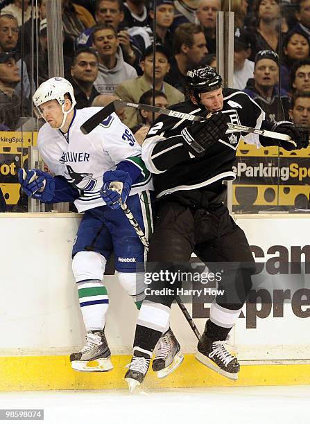 Jannick Hansen of the Vancouver Canucks takes a check from Matt Greene of the Los Angeles Kings during the first period in game four of the Western...