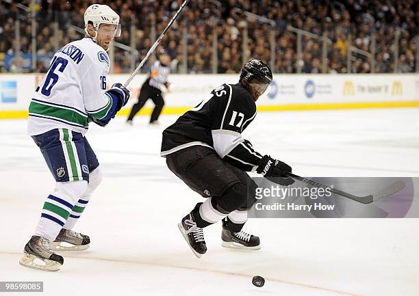 Wayne Simmonds of the Los Angeles Kings goes after a puck with Aaron Rome of the Vancouver Canucks during the first period in game four of the...