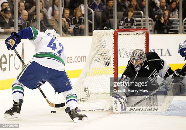 Jonathan Quick of the Los Angeles Kings stops Kyle Wellwood of the Vancouver Canucks during the first period in game four of the Western Conference...