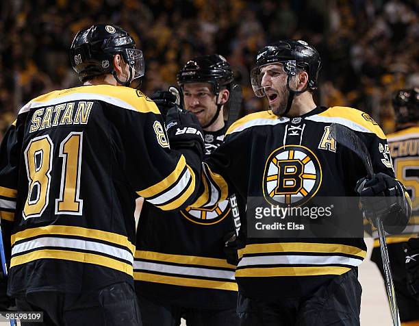 Patrice Bergeron of the Boston Bruins congratulates Miroslav Satan after he scored the game winning goal against the Buffalo Sabres in Game Four of...
