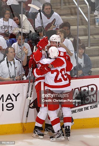 Jonathan Ericsson, Justin Abdelkader and Drew Miller of the Detroit Red Wings celebrate after Justin Abdelkader scored a third period goal against...