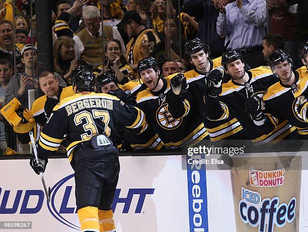 Patrice Bergeron of the Boston Bruins is congratulated by teammates after he scored the goal to tie the game against the Buffalo Sabres in Game Four...