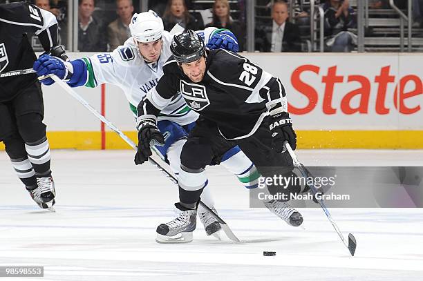 Jarett Stoll of the Los Angeles Kings skates with the puck against Shane O'Brien of the Vancouver Canucks in Game Four of the Western Conference...