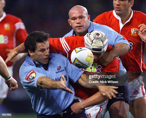 Brendan Cannon of the Waratahs releases the ball despite the tackle of Phil Vickery of the Lions during the game between British and Irish Lions and...