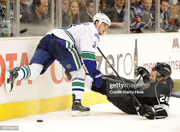 Kevin Bieksa of the Vancouver Canucks is called for interference on Alexander Frolov of the Los Angeles Kings during the second period in game four...