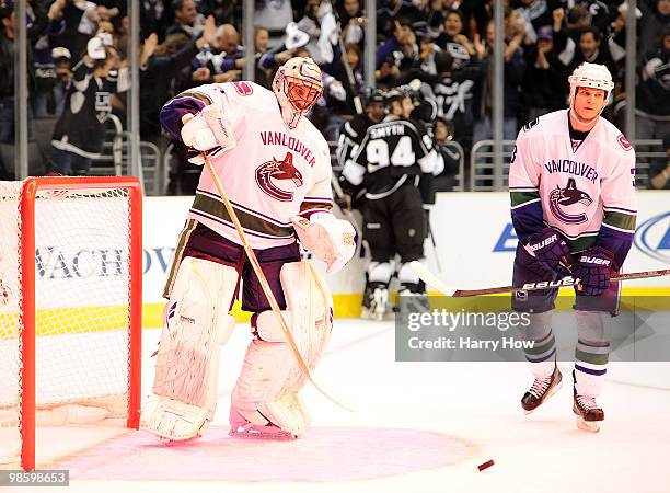 Roberto Luongo and Kevin Bieksa of the Vancouver Canucks react after a goal by Anze Kopitar of the Los Angeles Kings during the second period in game...