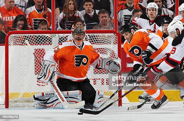 Dainius Zubrus of the New Jersey Devils takes a shot on goal against Brian Boucher and Ian Laperriere of the Philadelphia Flyers in Game Four of the...