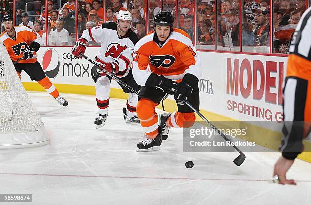 Colin White of the New Jersey Devils skates after Dan Carcillo of the Philadelphia Flyers as he skates the puck out from behind the net in Game Four...