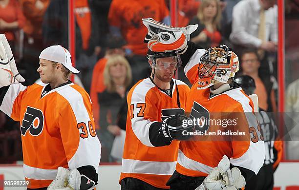 Johan Backlund, Jeff Carter and Brian Boucher of the Philadelphia Flyers all celebrate a 4-1 win over the New Jersey Devils in Game Four of the...