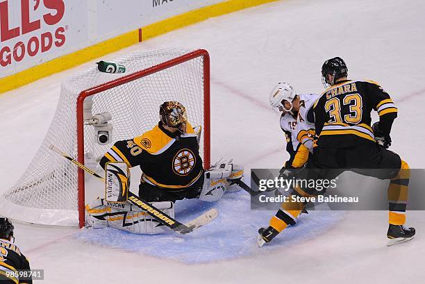 Jason Poinville of the Buffalo Sabres tries to take a shot against Tuukka Rask and Zdeno Chara of the Boston Bruins in Game Four of the Eastern...