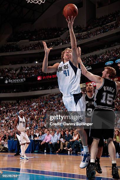 Dirk Nowitzki of the Dallas Mavericks goes in for the layup against Matt Bonner of the San Antonio Spurs in Game Two of the Western Conference...