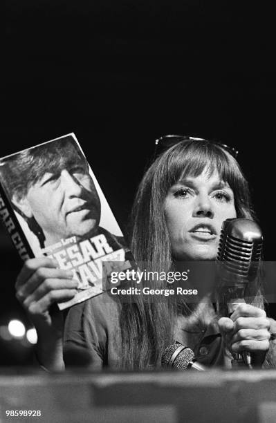 Political activist and Academy Award-winning actress, Jane Fonda, holds up a book on Cesar Chavez during the 1976 New York, New York, Democratic...