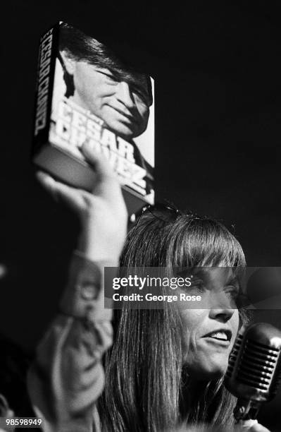 Political activist and Academy Award-winning actress, Jane Fonda, holds up a book on Cesar Chavez during the 1976 New York, New York, Democratic...